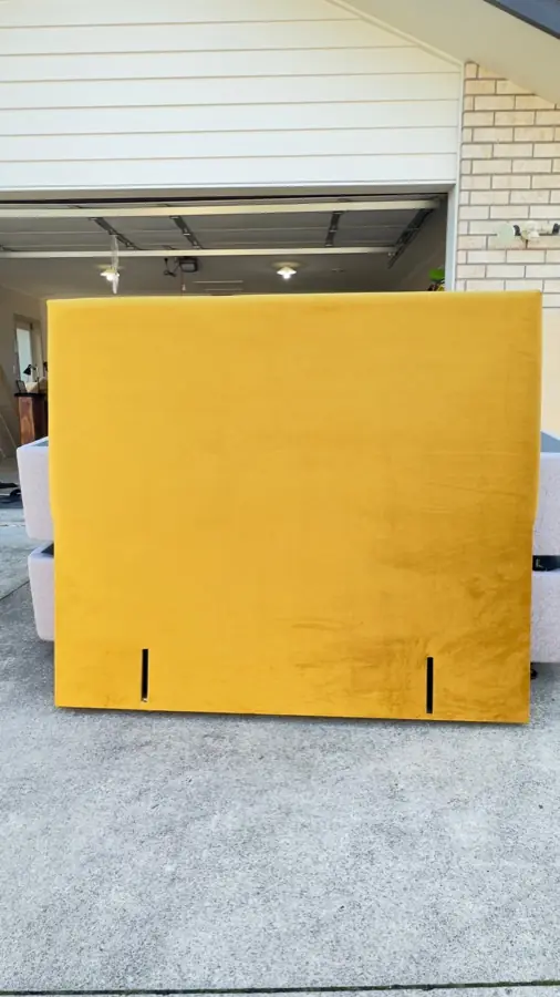 A mustard yellow headboard with a plain face, just finished.
